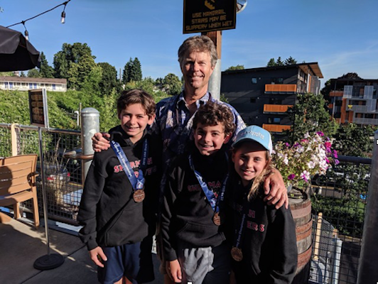 Sofie with Michael Solomon (left), who dove in the Boys 12-13 age group in both the 1 meter and 3 meter springboard events, placing 7th on 3m and 6th on 1m. and brother Jake Solomon who competed in the Boys 11 & Under 1 meter event, placing 7th.