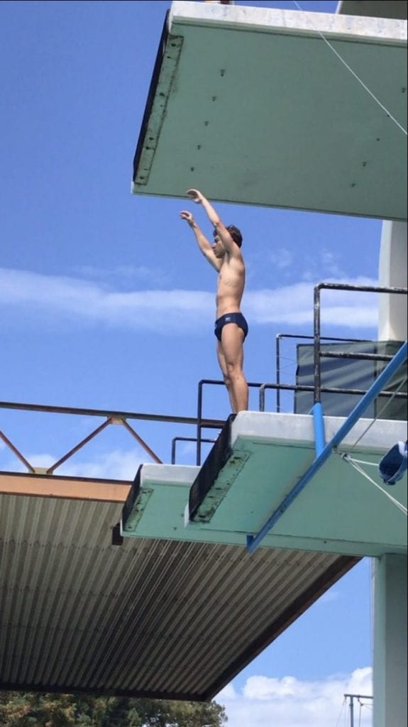 Zabronsky preparing for a reverse 1-1/2 somersaults from the 5 m platform.