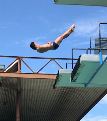 Daniel Zabronsky kicking out of a back dive tuck from the 5 meter platform.