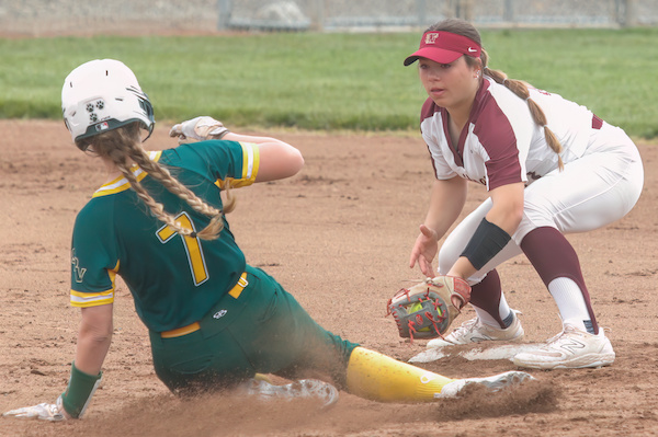 Whitney HIgh softball shortstop Alyssa Flindt tags out a San Ramon Valley baserunner sliding into second base during a 2023 game.