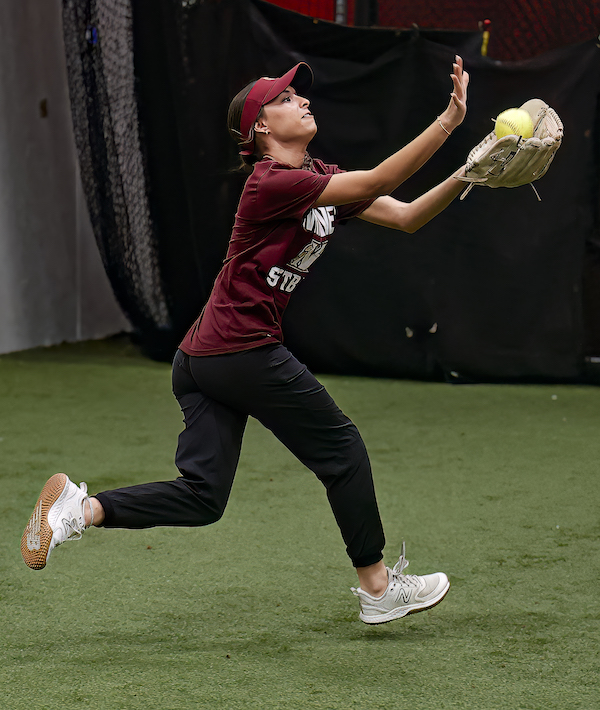 Whitney High softball infielder Madilyn Novello catches a pop fly during an indoor practice.