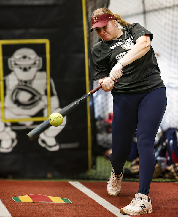Whitney High catcher Mya Flindt swings at a pitch during batting cage work